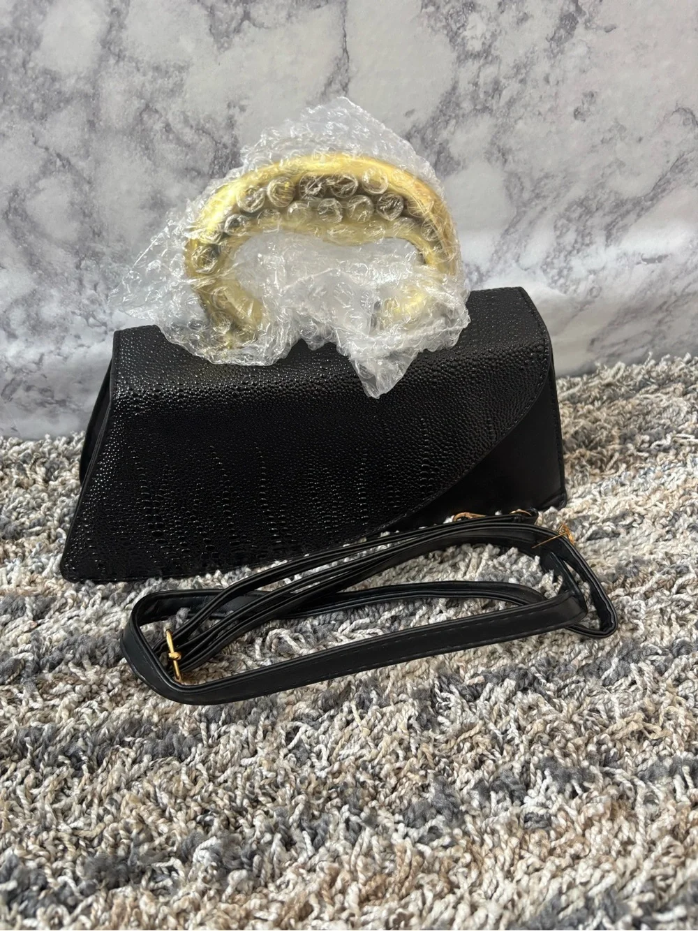 Elegant Black Textured Clutch with Gold Accent Handle